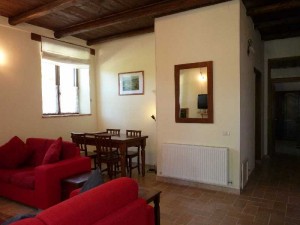 The interior of apartment Vettore at Casa Carotondo, Le Marche, Italy- walls divide the space into rooms. 