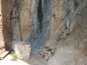 The small stone alter with cross and Madonna at the Eremo di Soffiano in the Sibillini Mountains, Le Marche, Italy