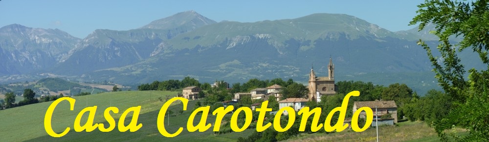 The hamlet of Pilotti, in the background the Sibillini Mountains, Le Marche, Italy